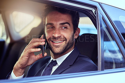 Buy stock photo Shot of a businessman talking on the phone while commuting to work