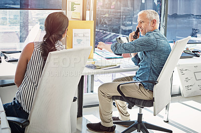 Buy stock photo Cropped shot of two colleagues working in the office