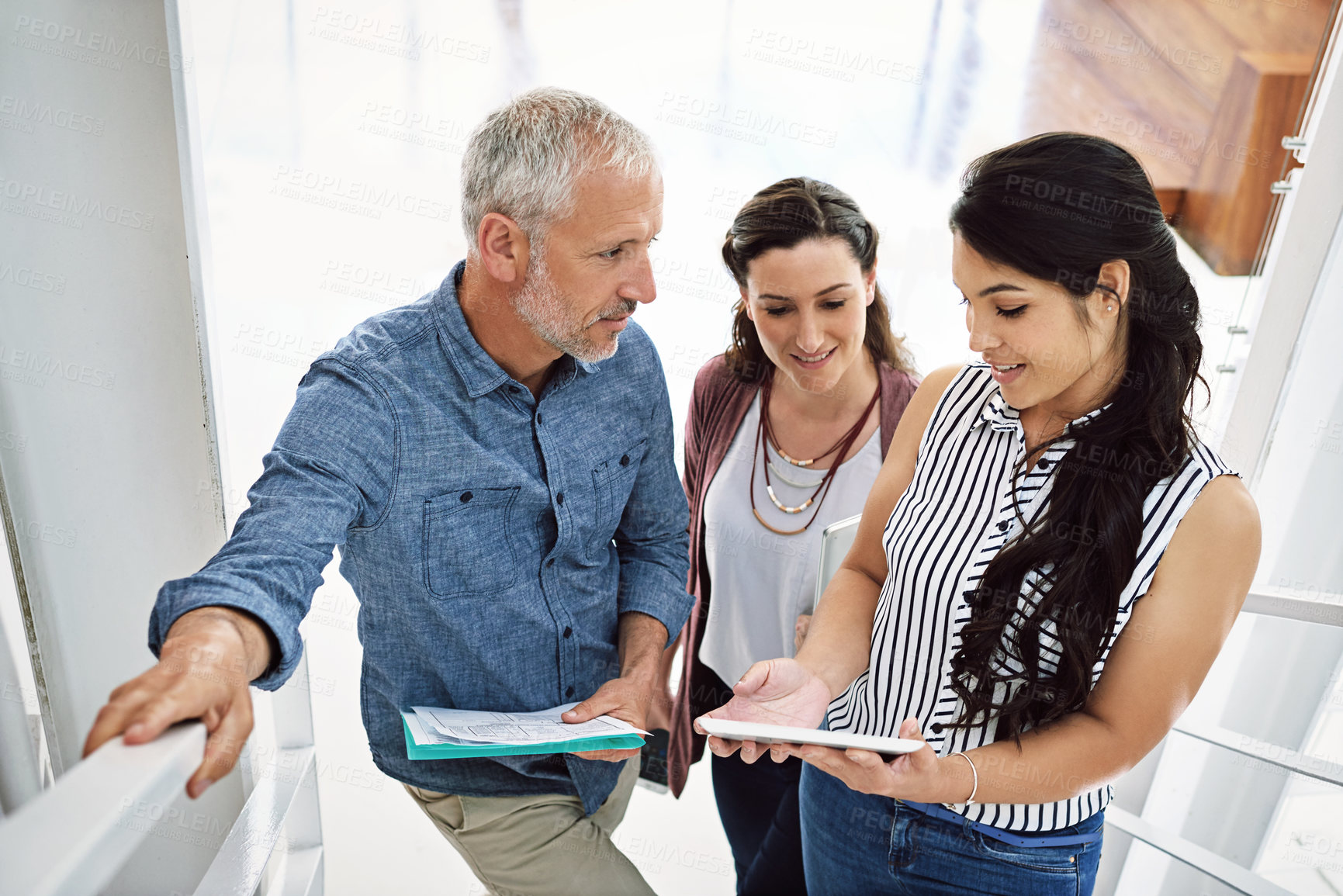 Buy stock photo Office, talking and business people on stairs with tablet, documents and project in meeting. Creative agency, marketing company and man with women on digital tech for research, website and teamwork
