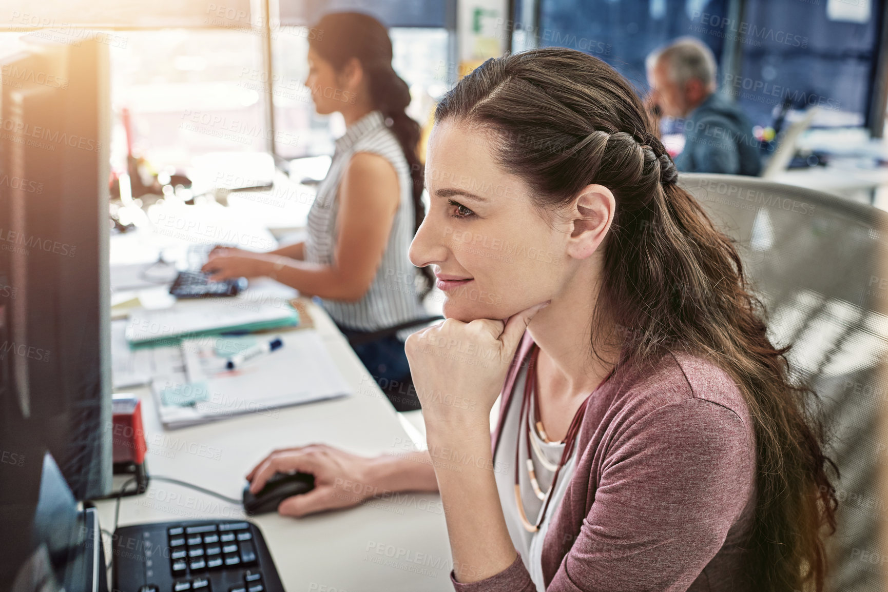 Buy stock photo Cropped shot of three colleagues working in the office