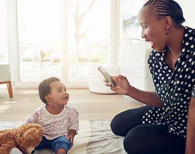 Buy stock photo Shot of a mother taking a photo of her baby girl