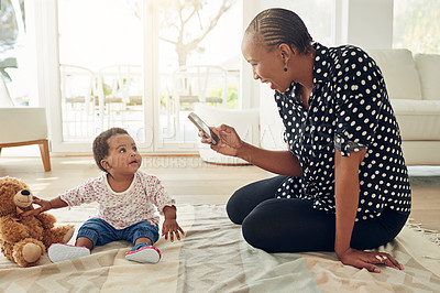 Buy stock photo Shot of a mother taking a photo of her baby girl