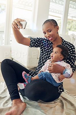 Buy stock photo Shot of a mother taking a photo with her baby girl