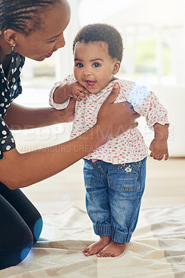 Buy stock photo Walking, learning and mom with baby in home for child development, growth and first steps. African family, motherhood and mother with young toddler for bonding, relationship and balance in house