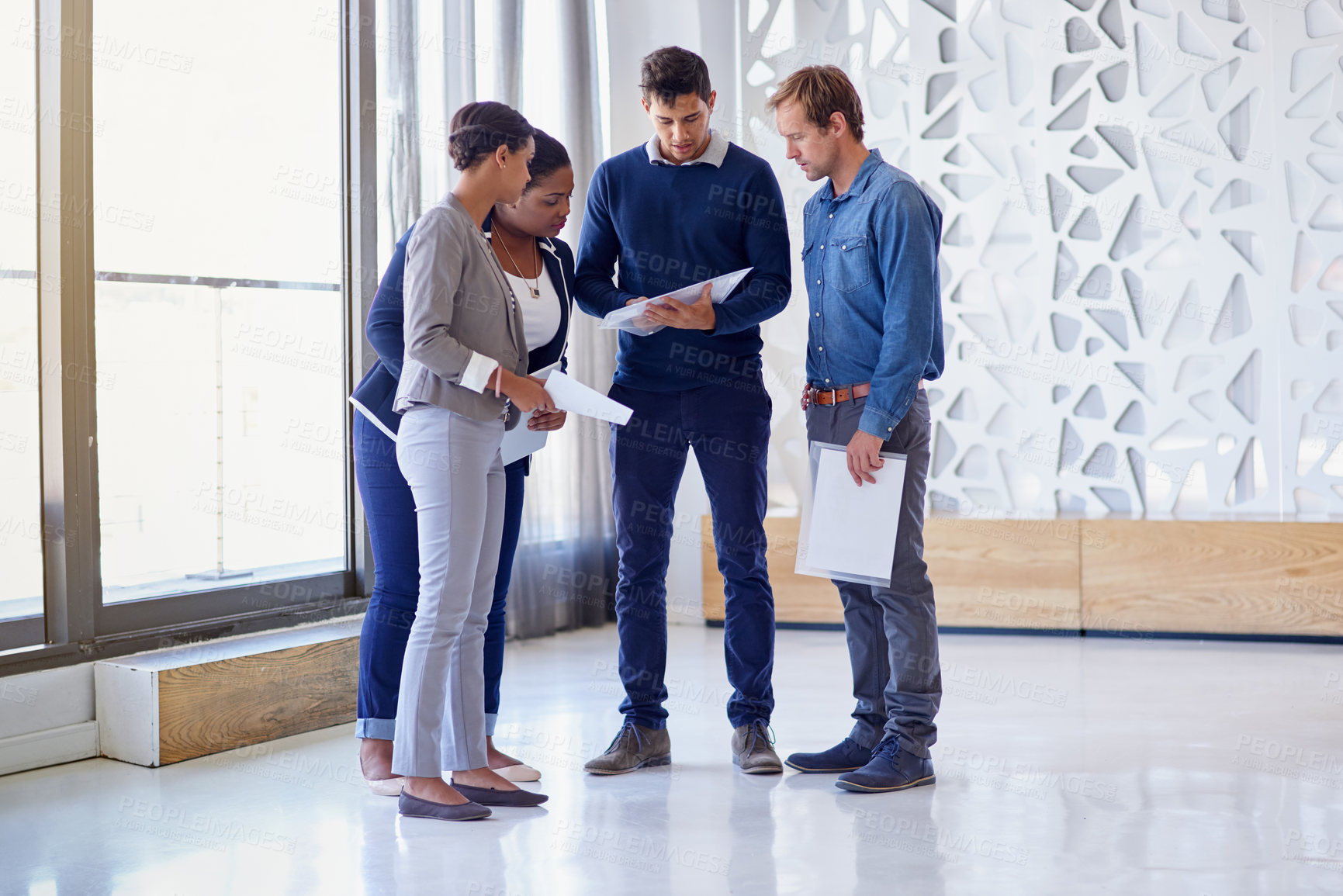 Buy stock photo Shot of a group of colleagues working together in an office