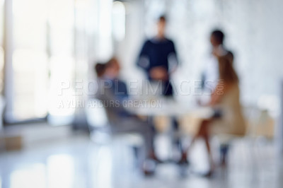 Buy stock photo Shot of a blurred group of colleagues working together in an office