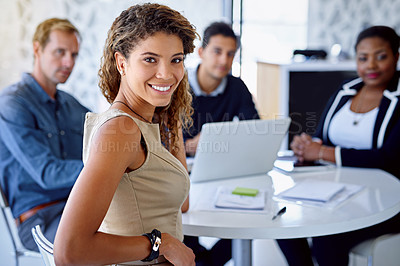 Buy stock photo Portrait of a young businesswoman with colleagues in the background