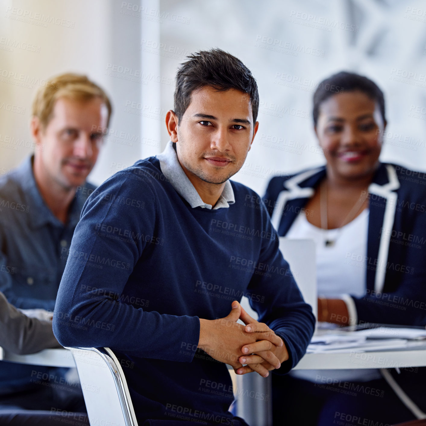 Buy stock photo Portrait of a young businessman with colleagues in the background