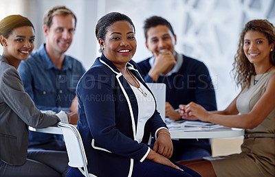 Buy stock photo Portrait of a group of smiling colleagues sitting in an office