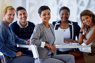Buy stock photo Portrait of a group of smiling colleagues sitting in an office