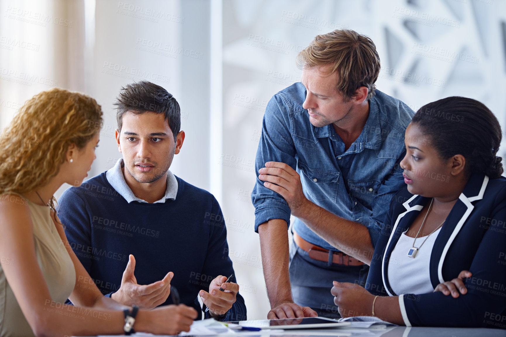 Buy stock photo Shot of a group of colleagues working together in an office