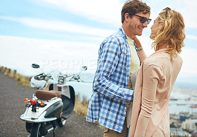 Buy stock photo Shot of a couple having a intimate moment while out on the road