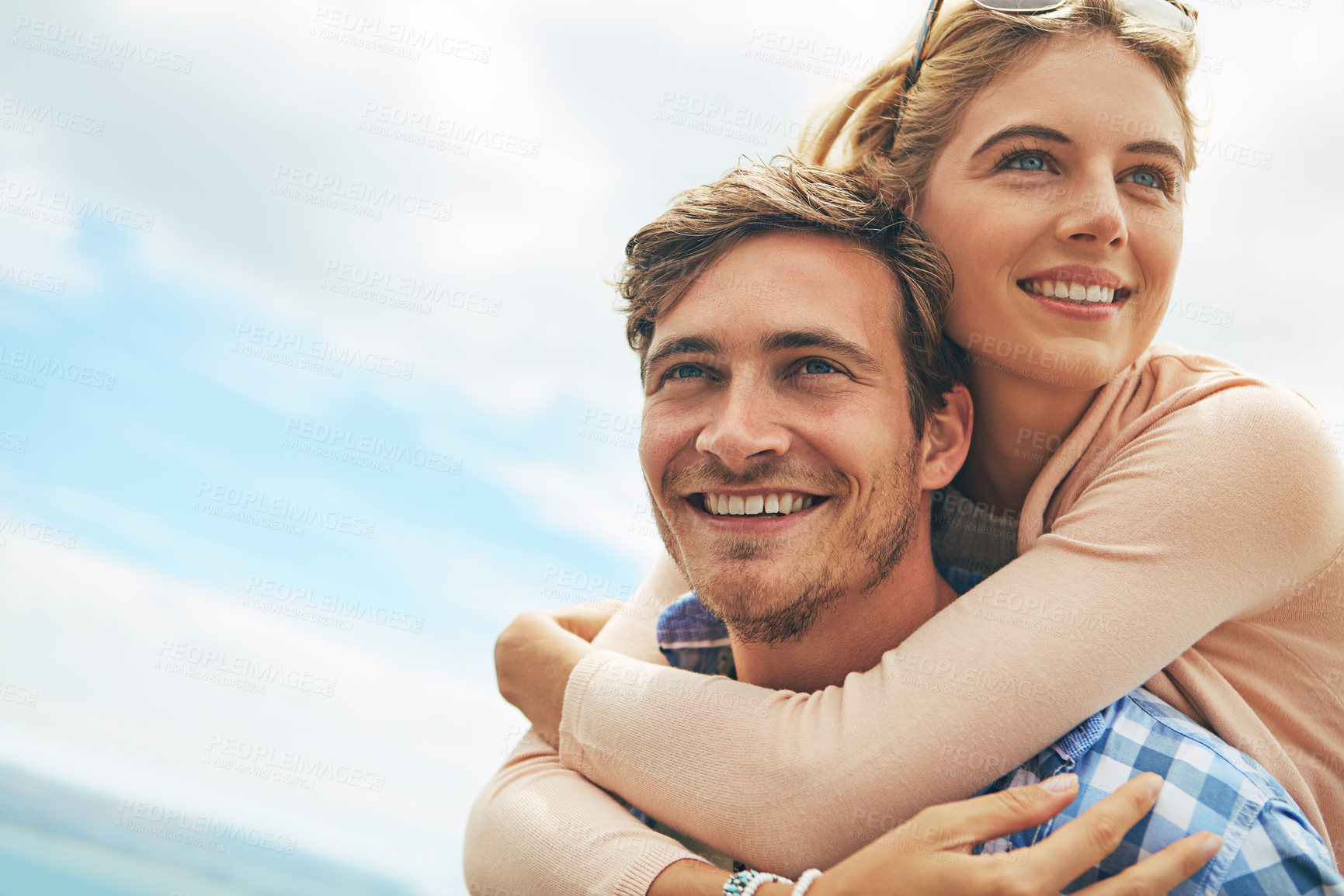 Buy stock photo Shot of a young man piggybacking his girlfriend