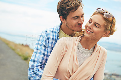 Buy stock photo Shot of a young couple enjoying a day outdoors