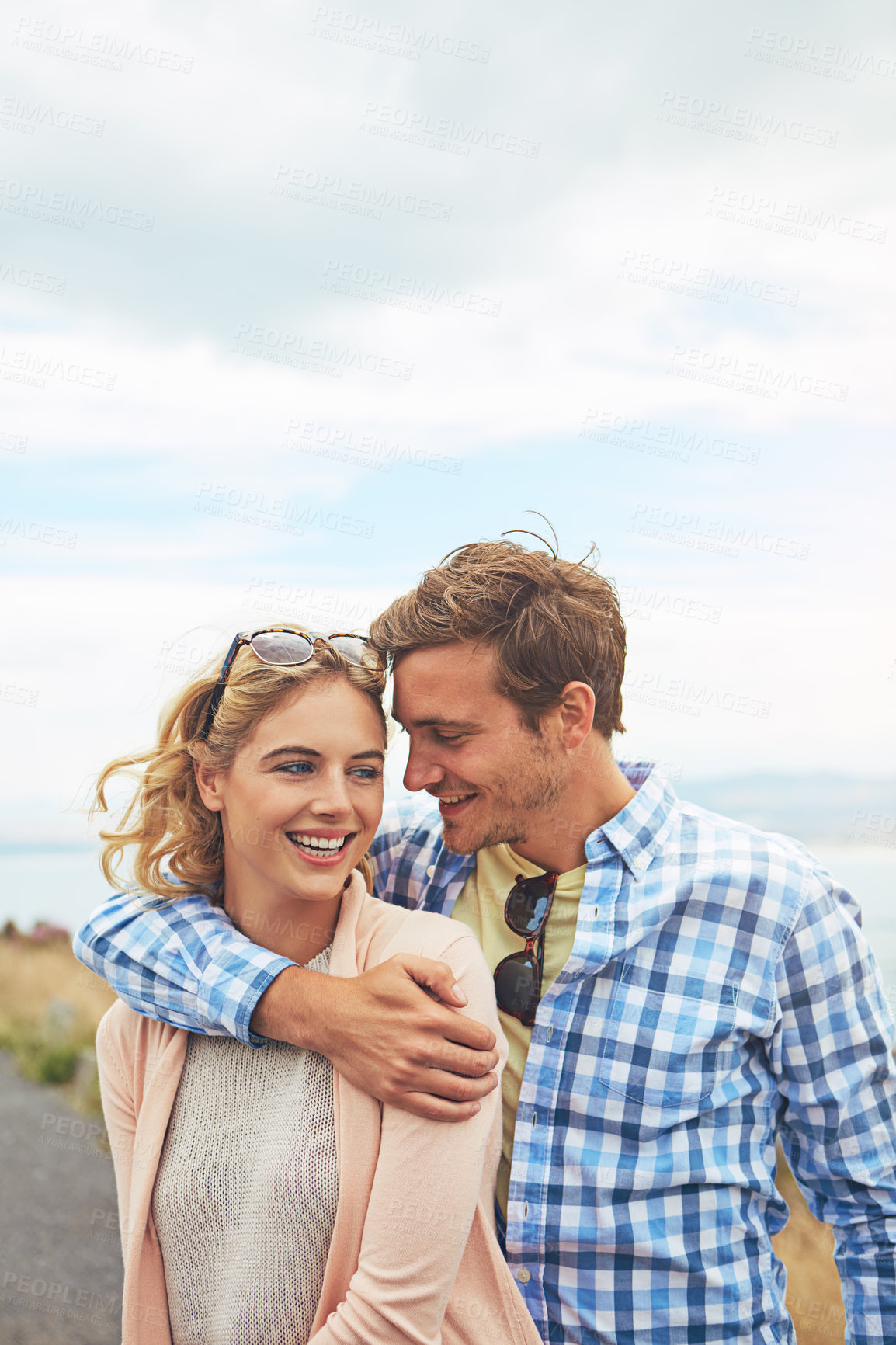 Buy stock photo Shot of a young couple enjoying a day outdoors