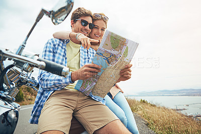 Buy stock photo Shot of a couple using a map while out on a road trip