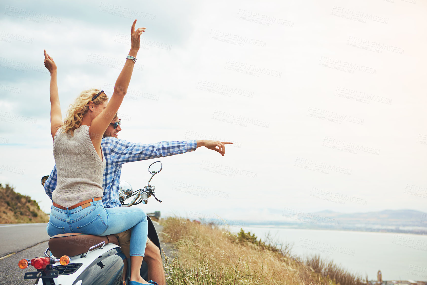 Buy stock photo Shot of a young couple out for a ride on a scooter