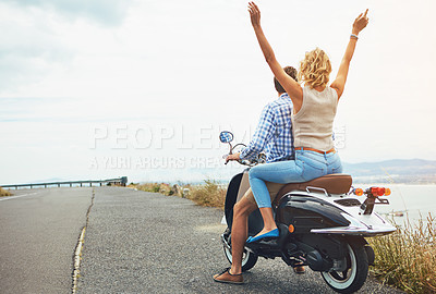 Buy stock photo Shot of a young couple out for a ride on a scooter