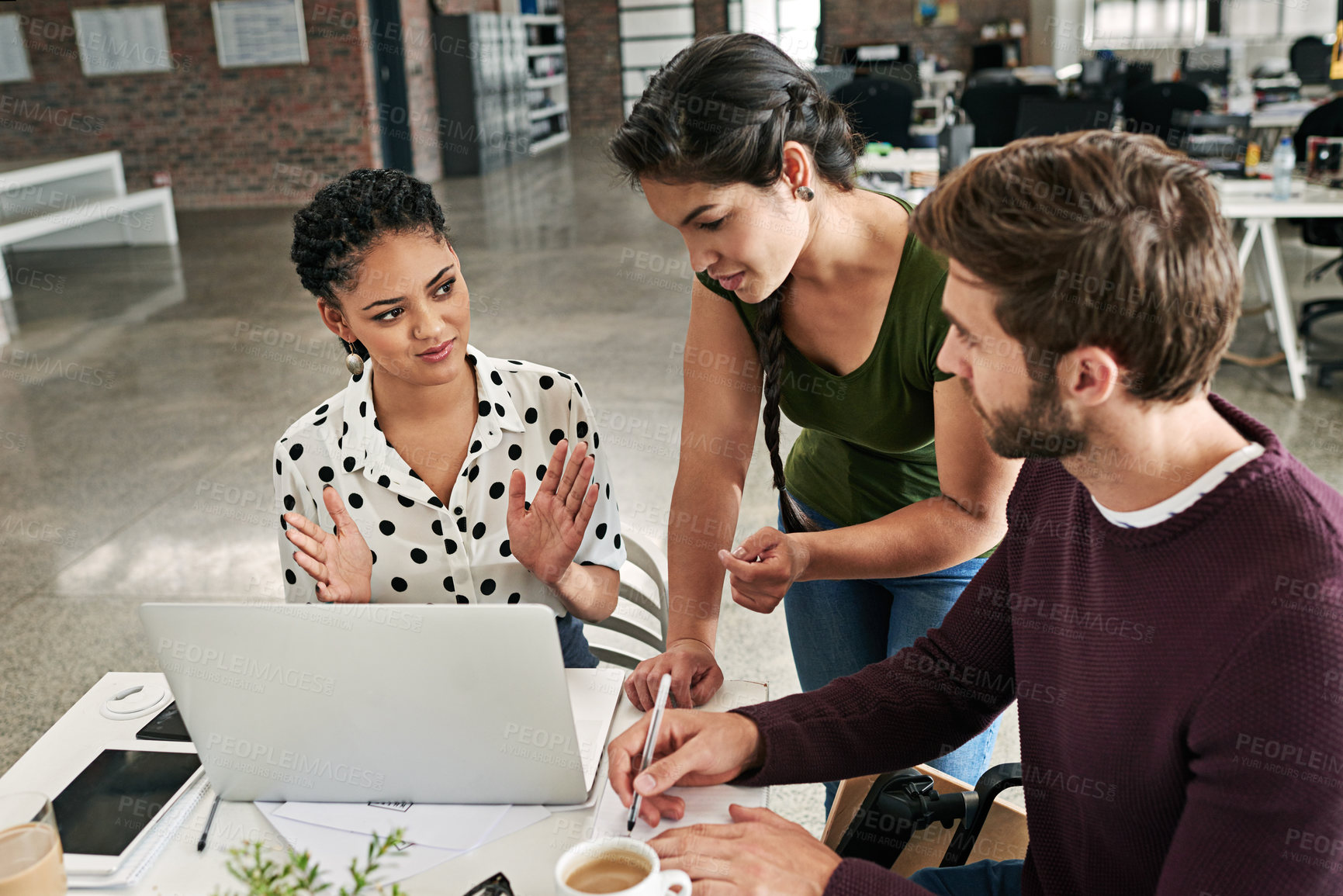 Buy stock photo Shot of a team of colleagues using a laptop together in a modern office