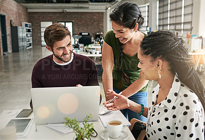 Buy stock photo Shot of a team of colleagues using a laptop together in a modern office
