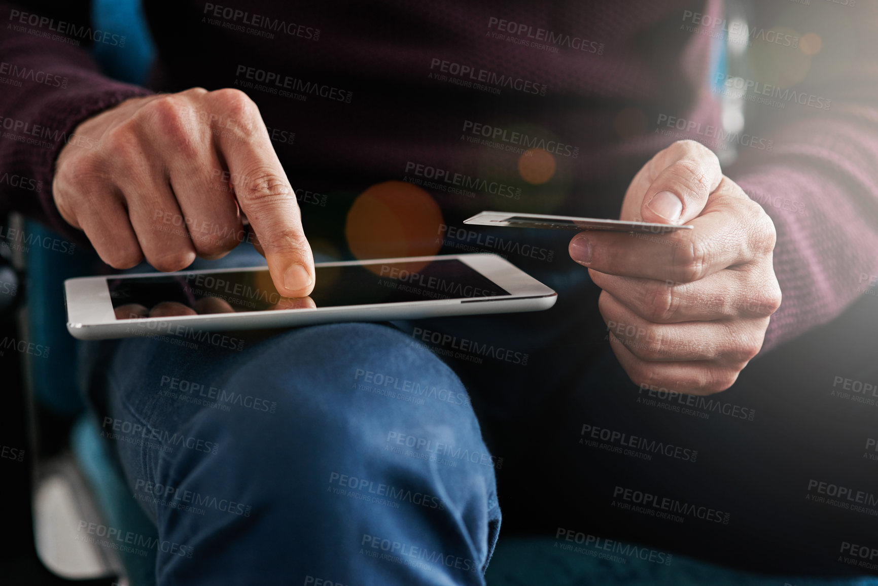 Buy stock photo Shot of a young man using a digital tablet in an office