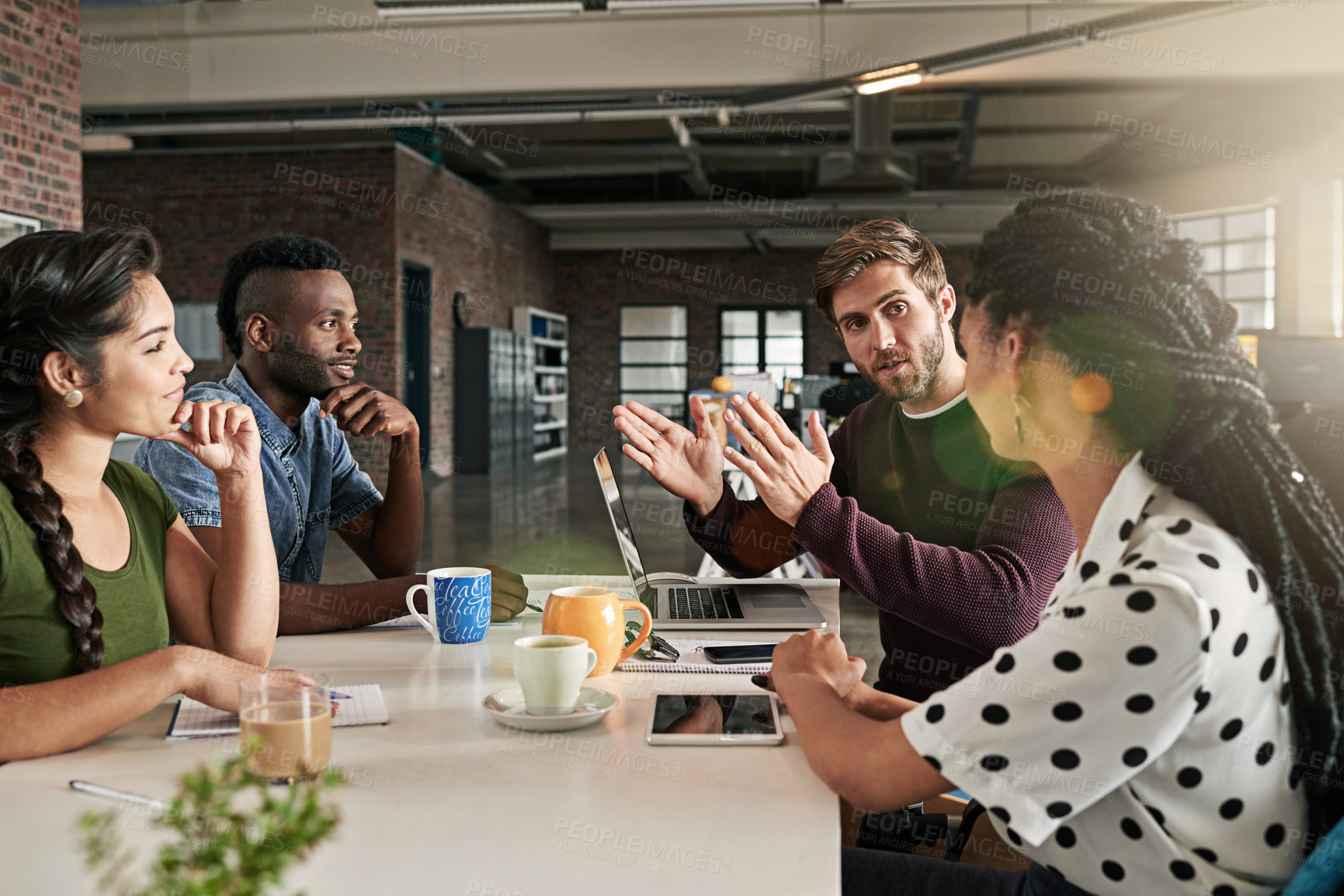 Buy stock photo Shot of a team of colleagues having a meeting in a modern office