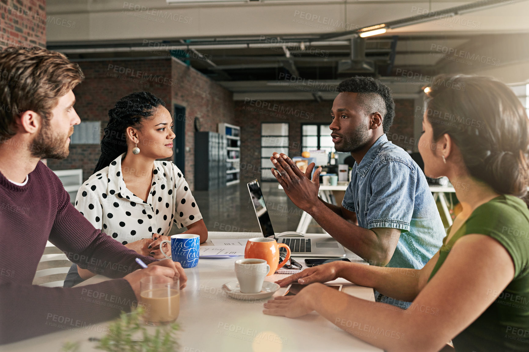 Buy stock photo Shot of a team of colleagues having a meeting in a modern office