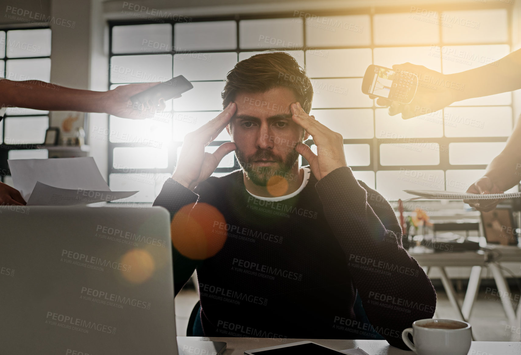 Buy stock photo Shot of a stressed out businessman surrounded by colleagues needing help