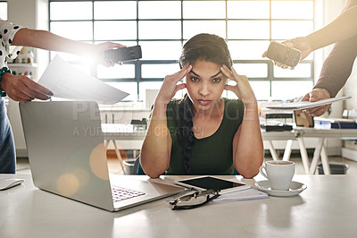 Buy stock photo Shot of a stressed out businesswoman surrounded by colleagues needing help