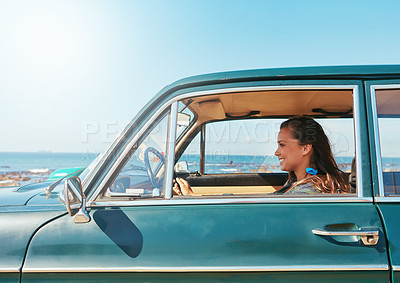 Buy stock photo Shot of a young woman on a road trip near the ocean