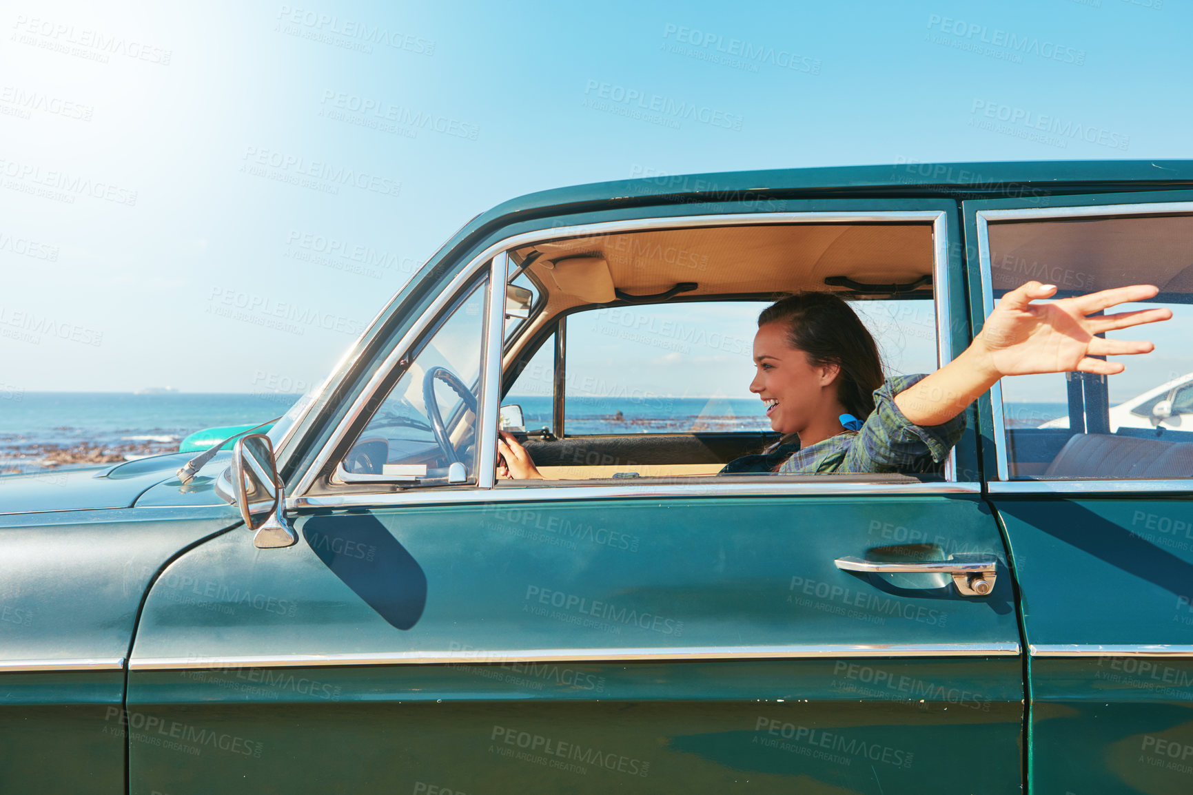 Buy stock photo Shot of a young woman on a road trip near the ocean