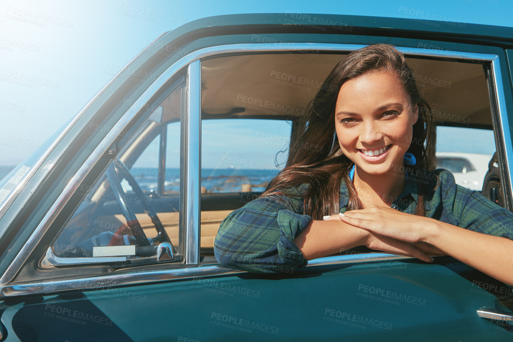 Buy stock photo Shot of a young woman on a road trip near the ocean