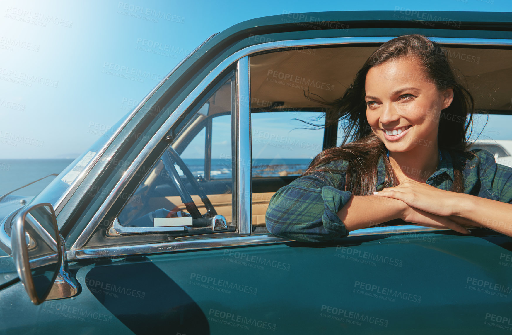 Buy stock photo Shot of a young woman on a road trip near the ocean