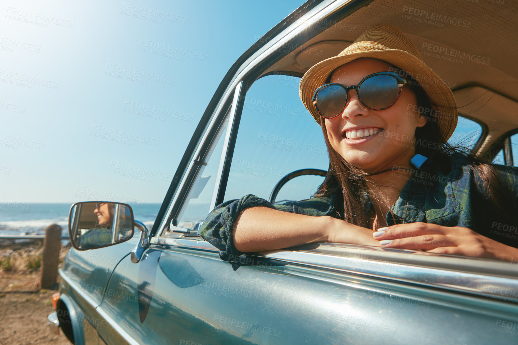 Buy stock photo Shot of a young woman on a road trip near the ocean