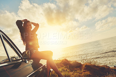 Buy stock photo Woman, sunset portrait and road trip on hood of car with smile, beach or happiness for summer vacation. Happy gen z girl, sky and sunshine with nature, outdoor adventure and holiday by ocean in Miami
