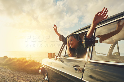 Buy stock photo Cropped shot of a young woman on a road trip to the beach at sunset