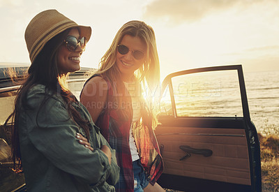 Buy stock photo Women, friends and smile by car at sunset, beach and road trip for talk on vacation in summer. People, happy and memory by vehicle, conversation or transport for journey, adventure and holiday by sea