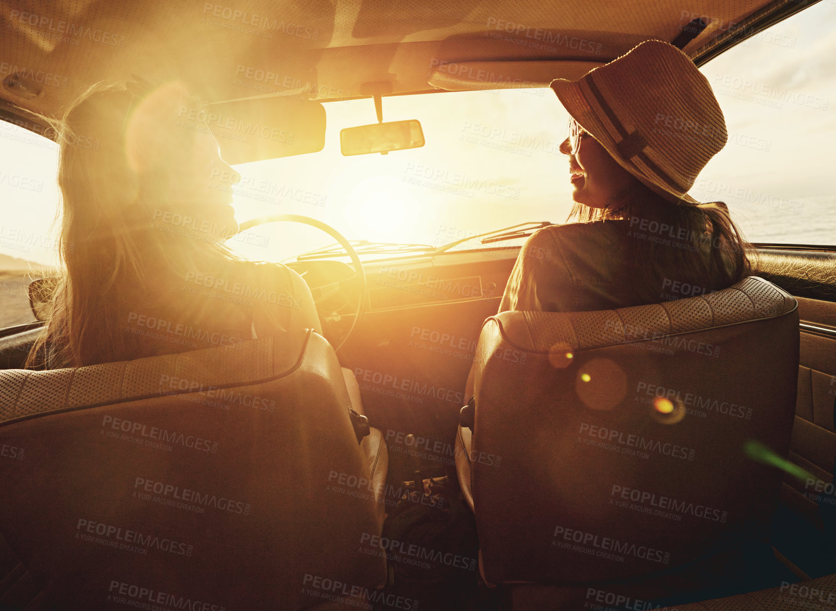 Buy stock photo Woman, friends and road trip for sunset travel, summer vacation or holiday relaxing in the car together. Happy women enjoying traveling journey, sunshine or driving freedom with lens flare by a beach