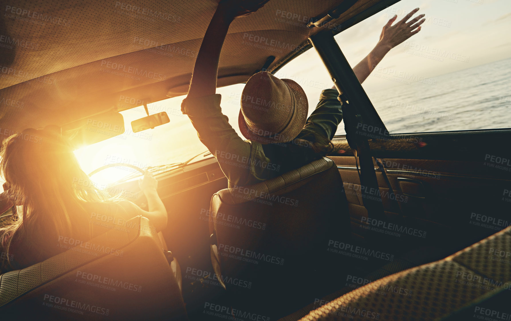 Buy stock photo Friends, women and sunset road trip at beach with car, hands and window in air for freedom, celebration or sea. Summer sunshine, vacation and ocean for driving, travel or nature by waves on adventure