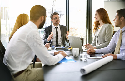 Buy stock photo Shot of a team of executives having a formal meeting in a boardroom