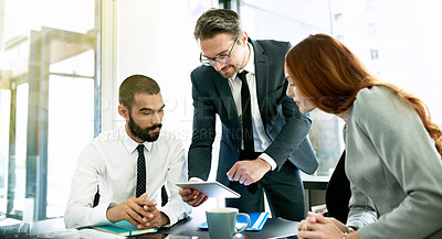 Buy stock photo Shot of a team of executives having a formal meeting in a boardroom