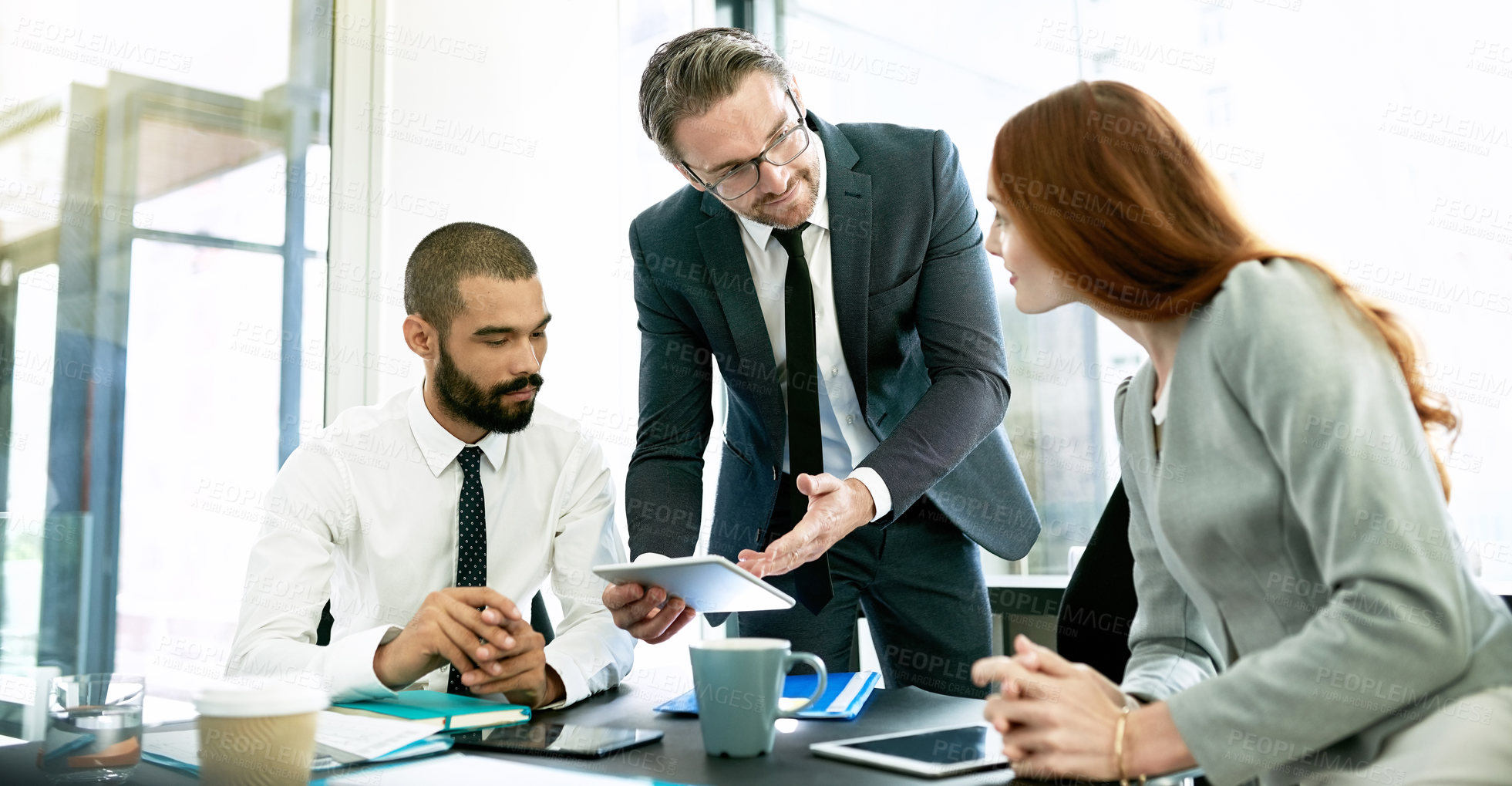 Buy stock photo Shot of a team of executives having a formal meeting in a boardroom