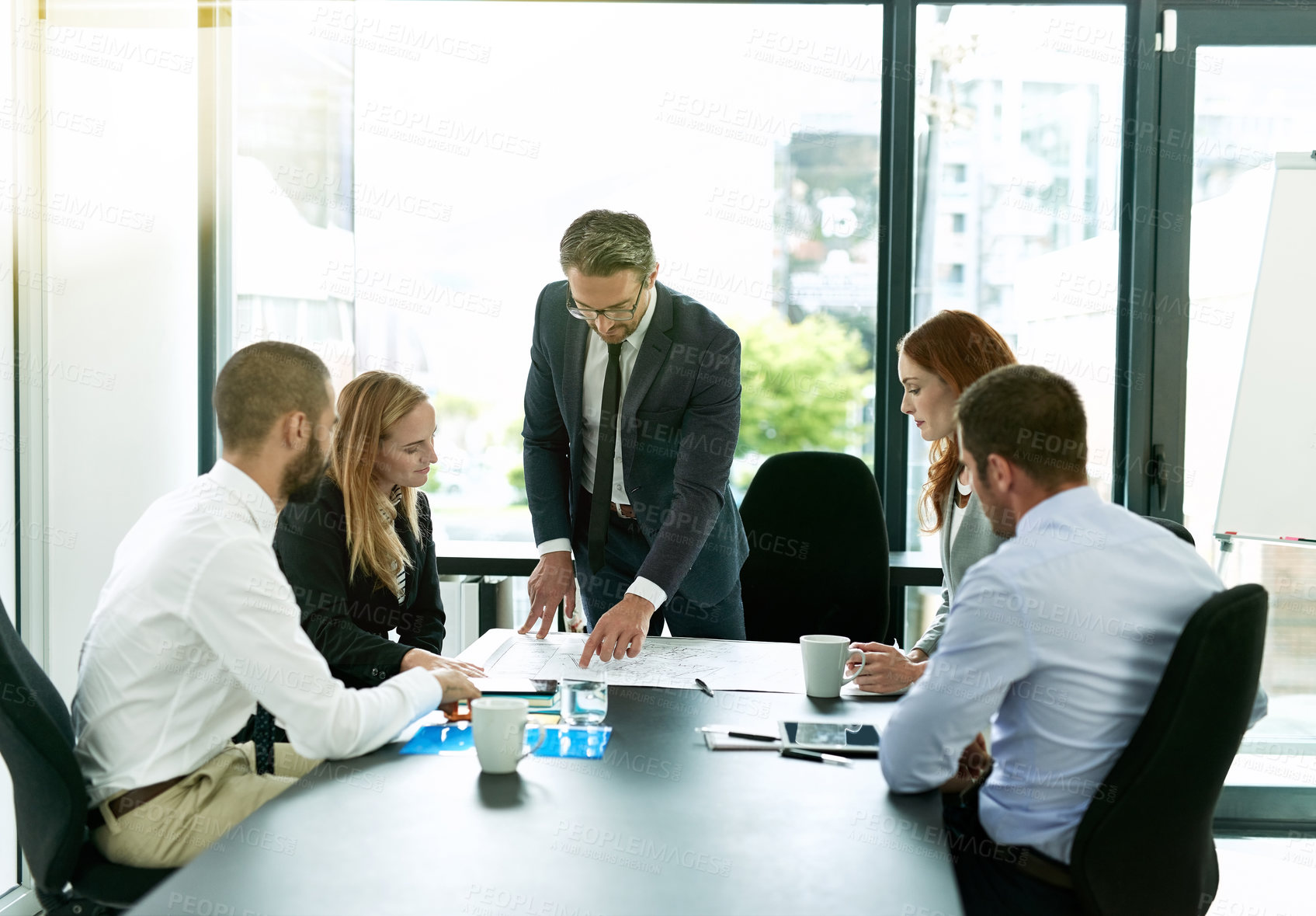 Buy stock photo Shot of a team of executives having a formal meeting in a boardroom