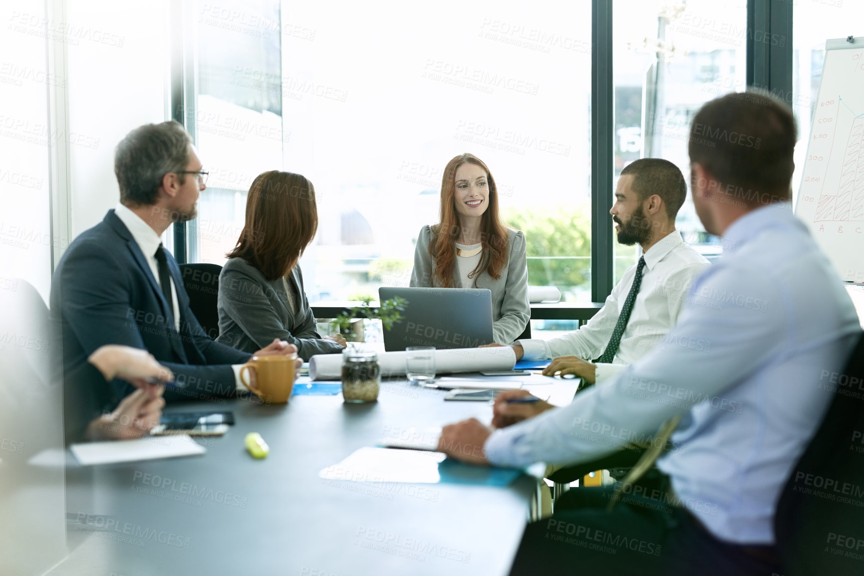 Buy stock photo Shot of a team of executives having a formal meeting in a boardroom