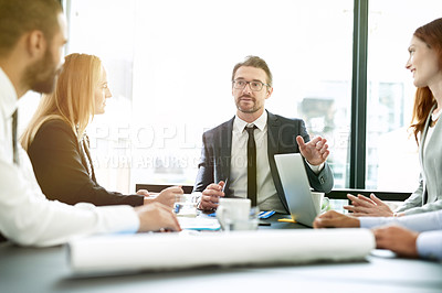 Buy stock photo Shot of a team of executives having a formal meeting in a boardroom