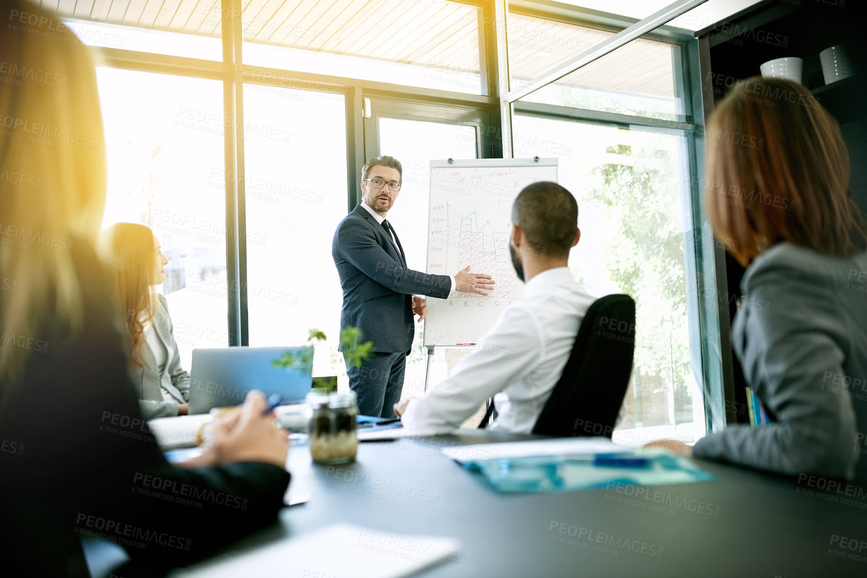 Buy stock photo Shot of a businessman giving a presentation to his colleagues in an office