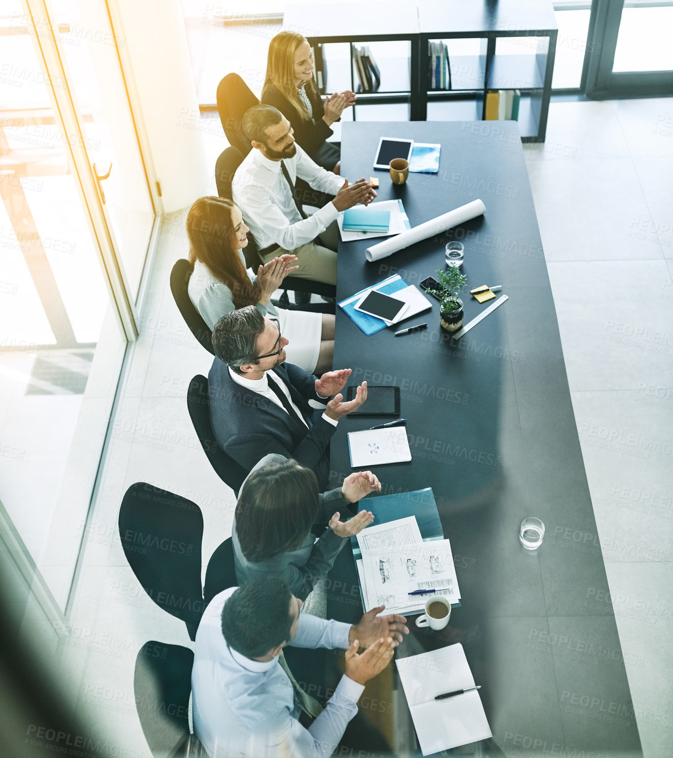 Buy stock photo Shot of a team of colleagues applauding during a formal meeting in a boardroom