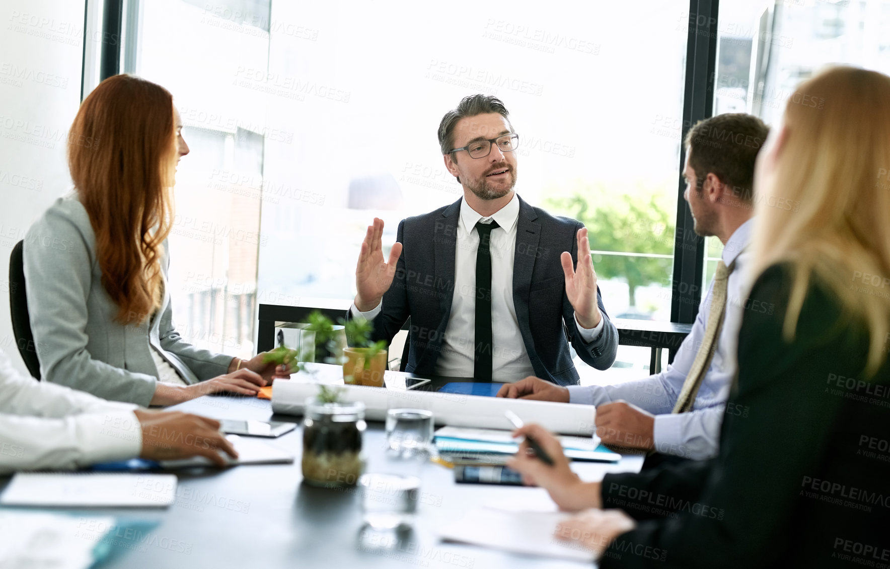 Buy stock photo Shot of a team of executives having a formal meeting in a boardroom