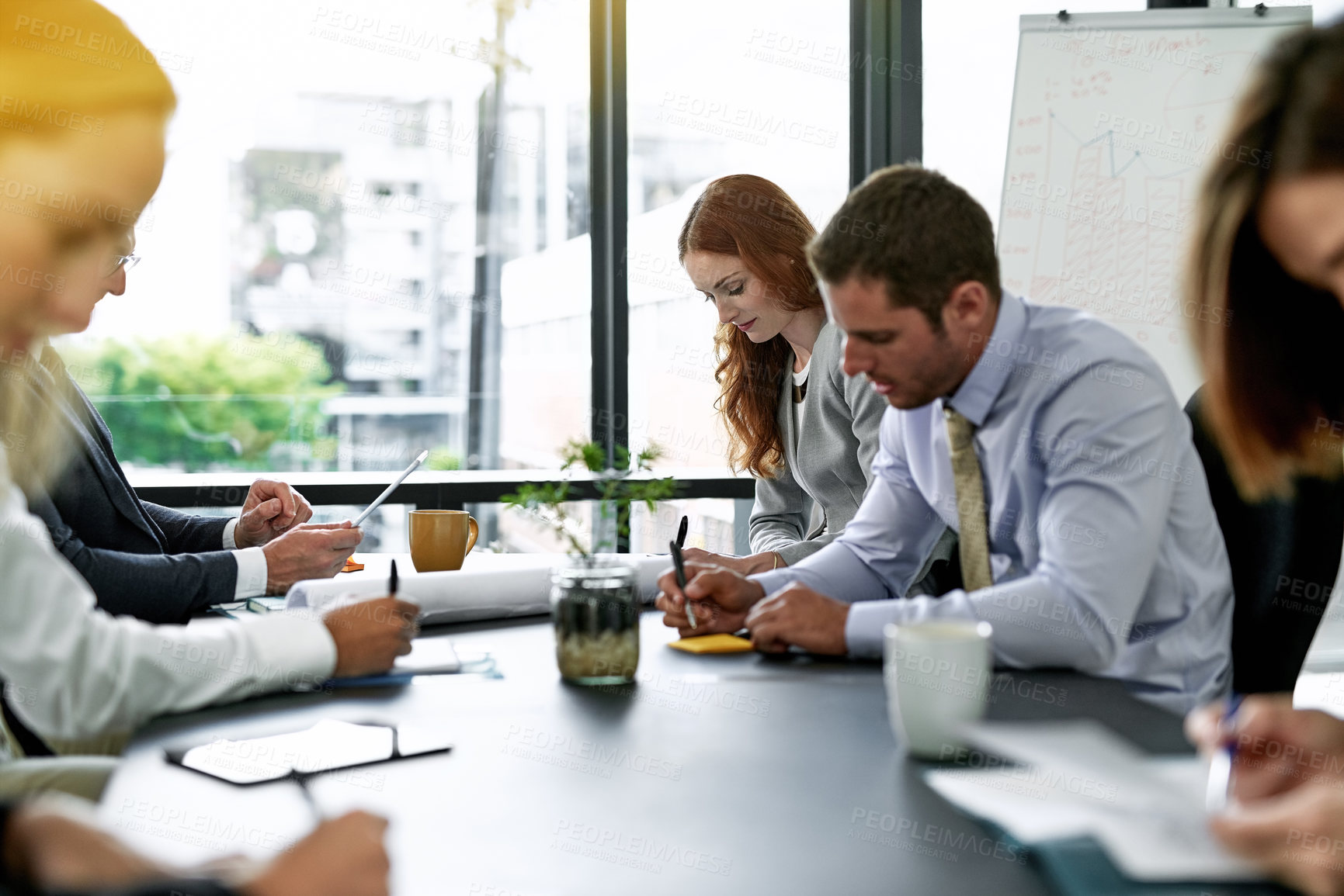 Buy stock photo Shot of a team of executives having a formal meeting in a boardroom