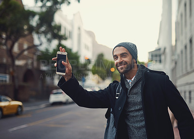 Buy stock photo Shot of a fashionable young man waving for a cab